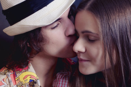 Portrait of  Couple young lovers kissing teen closeupの写真素材