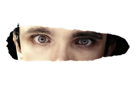Scary eyes of a man spying through a hole の写真素材