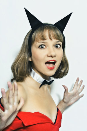 young woman in carnival costume with horns on a white backgroundの写真素材
