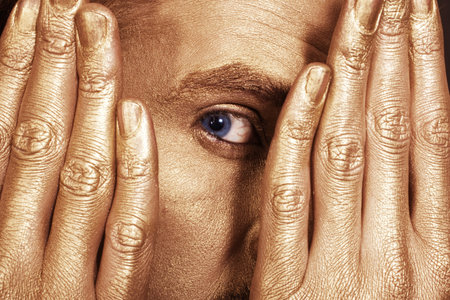 Eye of the young men in the gold make-upの写真素材