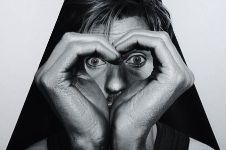 Silvery face of a young man with a heart symbol closeup