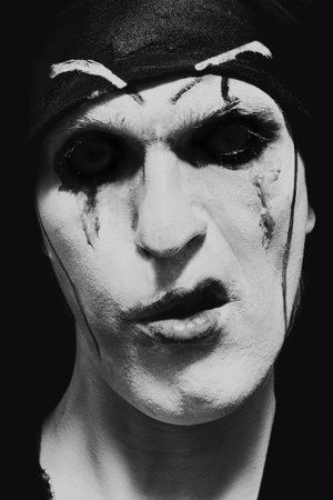 theatrical actor with dark makeup on her face close up