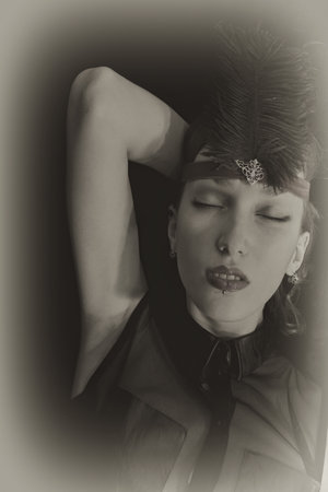 Portrait of a cabaret dancer wearing a headdress with a feather close up