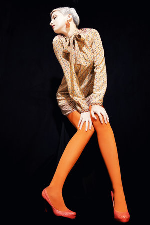 beautiful young woman with short hair on a black backgroundの写真素材