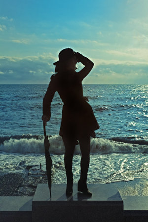 Young Woman with Umbrella on sea backgroundの写真素材