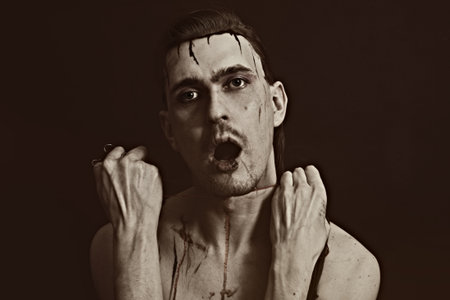 Studio portrait of a young man strangling himself thread closeupの写真素材