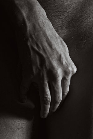Male hands covering crotch closeupの写真素材