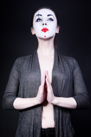  woman in  theatrical mime make-up on a black backgroundの写真素材