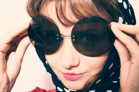 Portrait of a young woman wearing sunglasses and headscarf の写真素材