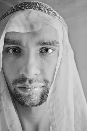 Portrait of a young man in the Arabian headscarf closeupの写真素材