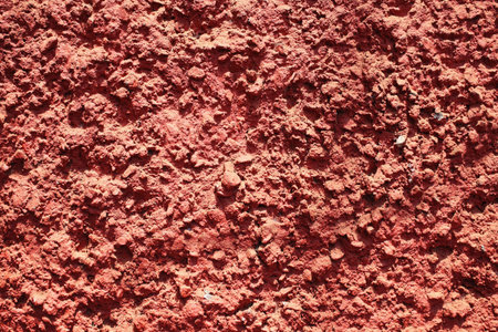 Texture of red bumpy cement wall close upの写真素材