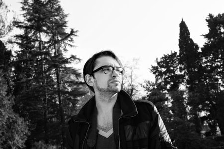 Portrait of a young man with glasses outdoorsの写真素材