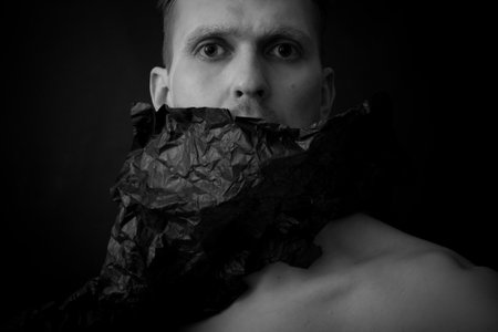 Studio portrait of a young man on a black background