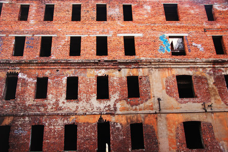 Facade of an old ruined brick buildingの写真素材