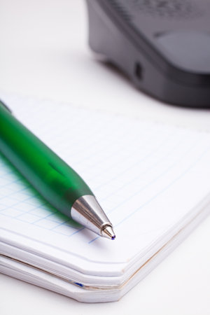 The green pen and notebook close upの写真素材