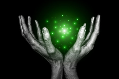 Men's silver hand with magical energy on a black backgroundの写真素材