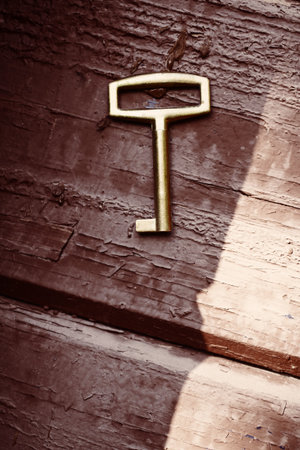 Old lost key on floorboards closeupの写真素材