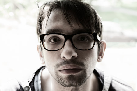 Portrait of young brunette man with glassesの写真素材