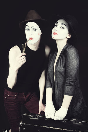 mimes woman and man with suitcase close upの写真素材