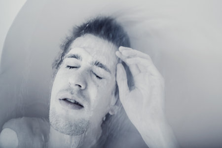 young sexual naked guy in bath close upの写真素材