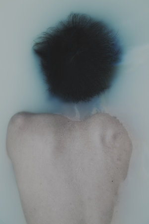 Portrait of a young handsome man taking a bathの写真素材