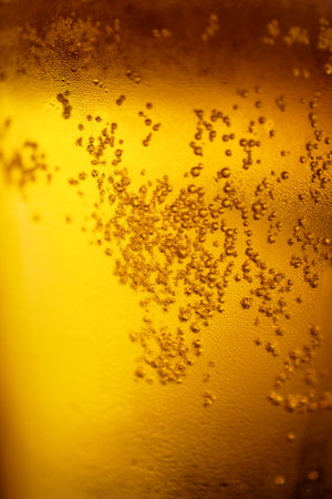 Background with yellow beer and bubbles closeupの写真素材