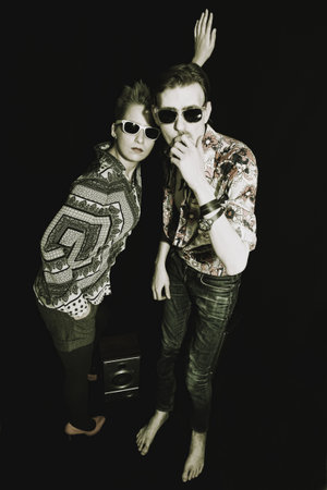 Portrait of stylish men and women on a black background