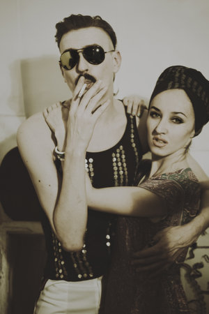 Portrait of a man dressed in sunglasses and a young womanの写真素材