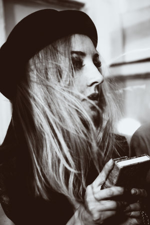 Portrait of a beautiful young woman holding a book in his handsの写真素材