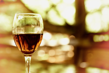 A glass with cognac glare in sunlightの写真素材