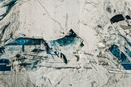 Texture of concrete wall with scraps of paper