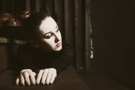 young woman lying on the wooden stepsの写真素材