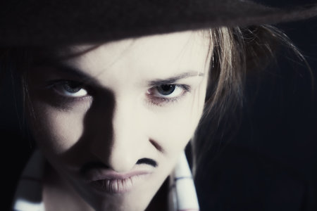 Face of young woman with mustache closeupの写真素材