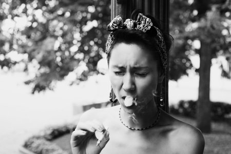 Portrait of young  smoking woman coughing tobacco smokeの写真素材