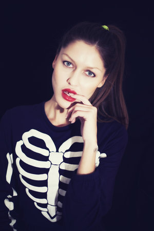 Portrait of young beautiful woman on black backgroundの写真素材