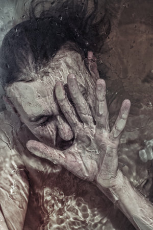 Portrait of a man drowning in the waterの写真素材