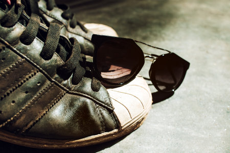 Old sneakers and sunglasses closeupの写真素材