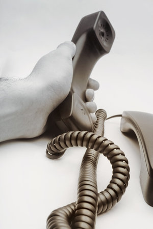 man's hand holding the phone on white backgroundの写真素材