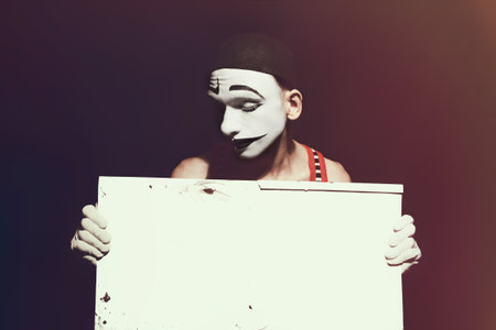 Portrait of mime holding white dirty sheet in handsの写真素材