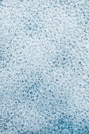 The texture of porous gray sponge closeup
