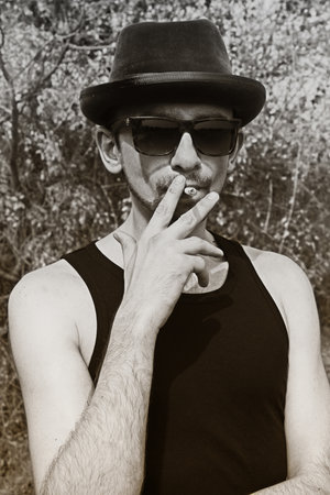 Portrait of young man wearing a hat and sunglassesの写真素材