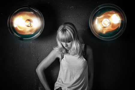 Portrait of  beautiful young girl against the backdrop  wall with spotlightsの写真素材