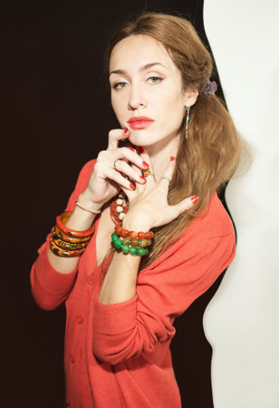 Portrait of a beautiful young woman with red manicure closeupの写真素材