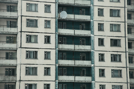 The facade of a residential building with square windowsの写真素材