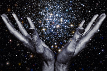 God's hands holding a star galaxy in spaceの写真素材