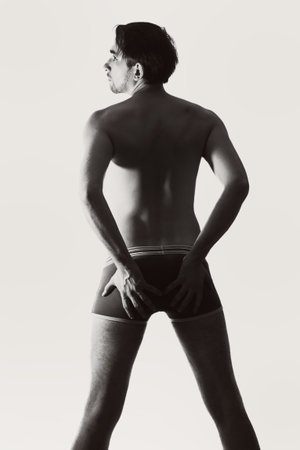 Young naked man on a white backgroundの写真素材
