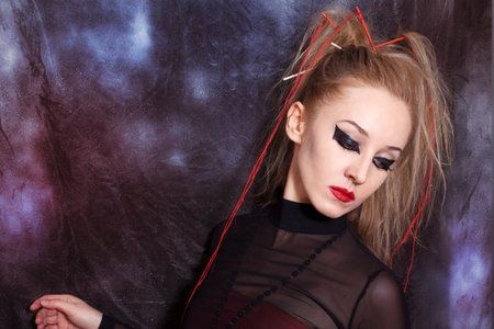 Portrait of beautiful young woman with bright gothic makeup closeupの写真素材