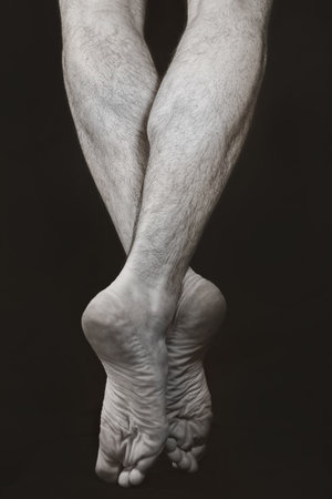 Barefooted male legs standing on tiptoe. Dance Artの写真素材