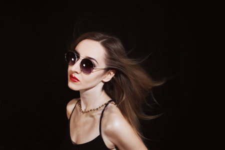 Portrait of a young woman wearing a sunglassesの写真素材