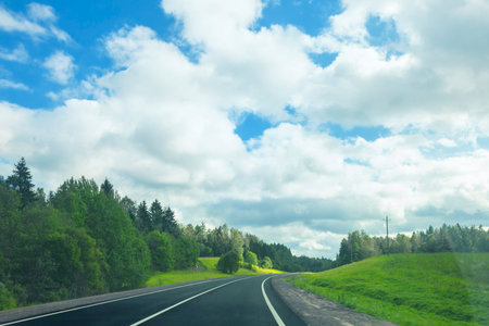 Landscape with an asphalt road in a sunny summer dayの写真素材